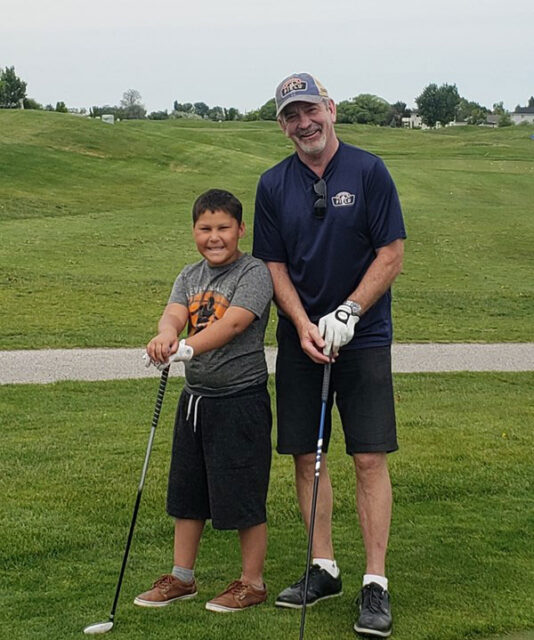Photo of Mentor Father George and Field Buddy Kamdyn Golfing